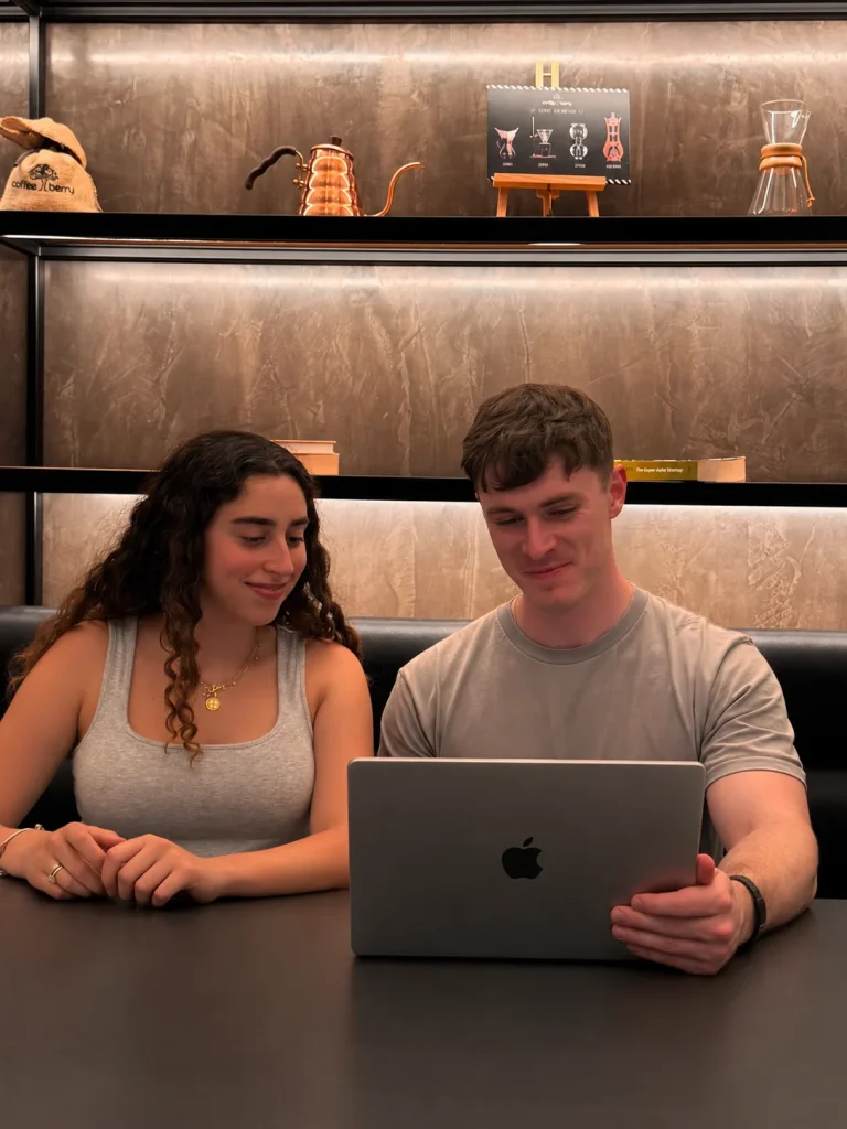 Lily and Dan, co-founders of The Social Bay, at a laptop